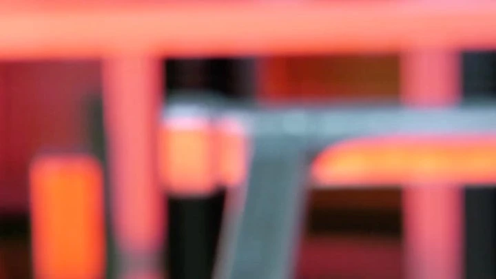 Abstract blurry image featuring various shades of red, orange, black, and gray, with a low depth of field.