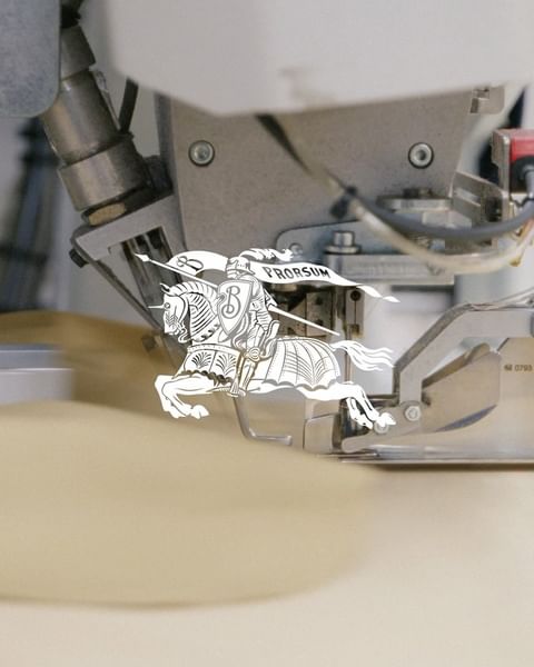 Close-up of a metal industrial machine featuring a graphic paper art image of a knight on horseback with a banner that reads 'PRORSUM'.