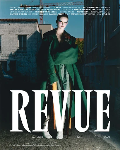 Fashion editorial featuring a model in a green coat and skirt in an urban setting, against a backdrop of buildings, with a magazine cover.