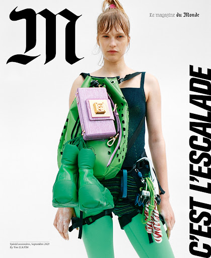 Magazine cover featuring a woman with a bright green backpack, lilac purse, and matching climbing shoes, set against a white background.