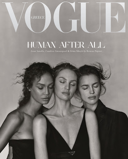 Black-and-white Vogue cover with three fashion models, Joan Smalls, Candice Swanepoel and Irina Shayk, eyes closed, in dresses and a blazer.