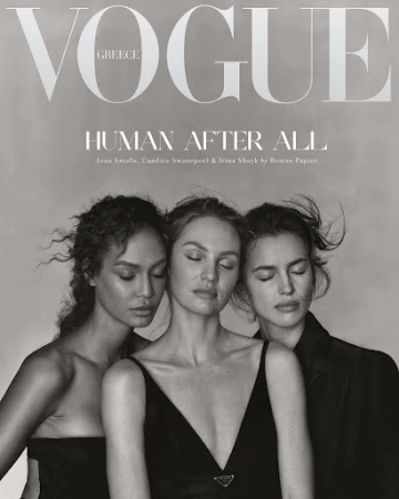 Black-and-white Vogue cover with three fashion models, Joan Smalls, Candice Swanepoel and Irina Shayk, eyes closed, in dresses and a blazer.