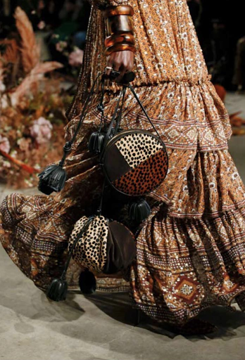 Fashionable boho chic outfit featuring an animal-print handbag and a long, patterned dress, perfect for bohemian style inspiration.