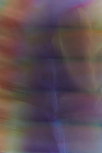 Abstract gradient background with blended hues of purple, pink, yellow, and green creating a soft, painterly effect in a vertical format.