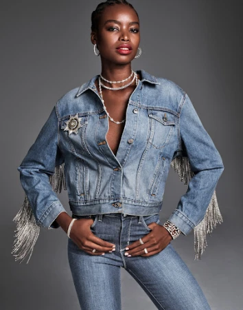 Black woman wearing denim jacket with rhinestone fringe and matching jeans styled by Daniel Edley