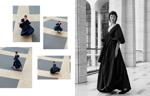 Fashion shot of woman in elegant dress posing in front of an architectural building with geometric floor, highlighting style and design.
