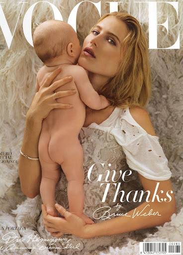 Magazine cover featuring a woman and a baby in a close embrace. The woman has long blond hair and is wearing a white top.