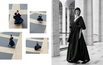 Model in a dark long-sleeved maxi dress walking among classical columns, styled by Deborah Watson.