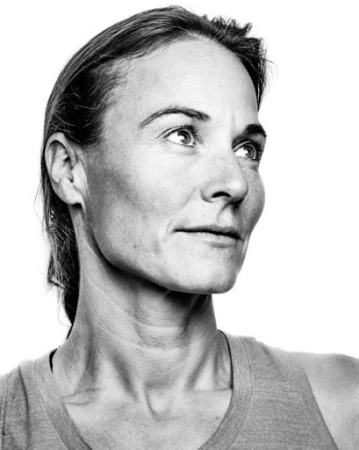 Black and white portrait of a woman looking upward, styled by Lauren Knudsen against a white background