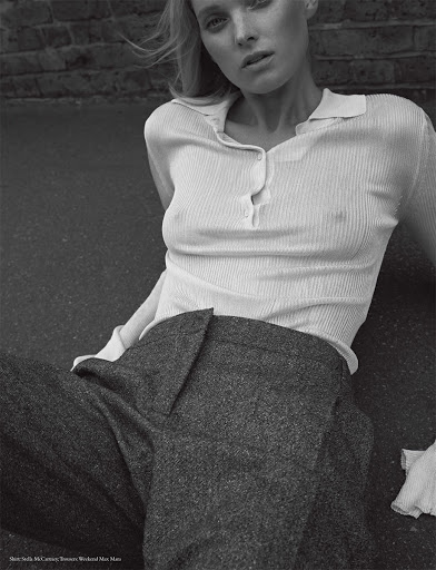 Monochrome fashion portrait of a model in a ribbed polo shirt and dark trousers outdoors