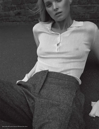 Monochrome fashion portrait of a model in a ribbed polo shirt and dark trousers outdoors