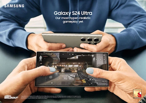Close-up of hands holding Samsung Galaxy S24 Ultra smartphones, showcasing realistic gameplay and cutting-edge mobile technology.