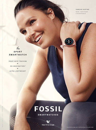 A woman smiles while showcasing a Fossil smart watch on her wrist, set against a bright backdrop with fitness-related promotional text.
