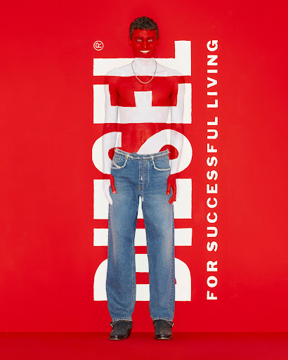 Diesel campaign featuring a male model with red-painted skin and denim jeans against a bold red backdrop with white logo text.