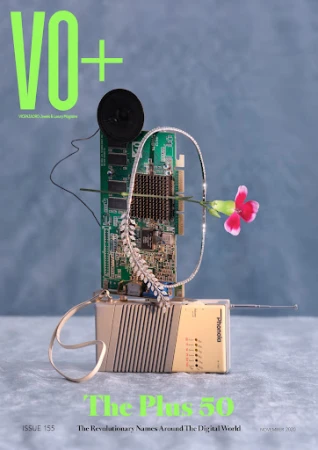 Magazine cover featuring vintage electronic devices, circuit board, jewelry, and flower against a hazy blue backdrop with neon green text.
