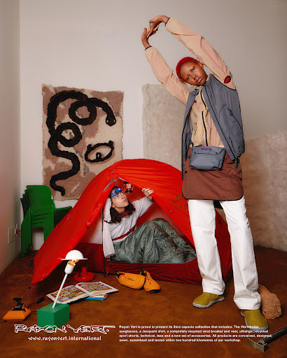 Two people in an indoor setting showcasing fashion and outdoor gear, featuring a tent, sporty outfits, and a casual indoor environment.