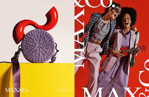 Fashion advertisement featuring two women smiling and holding a ukulele against a red backdrop, and a woven handbag on a yellow surface.