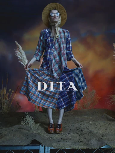 A fashion shot features a woman in a patchwork plaid outfit, straw hat, and sunglasses, posed on a small hill against a sunset backdrop.
