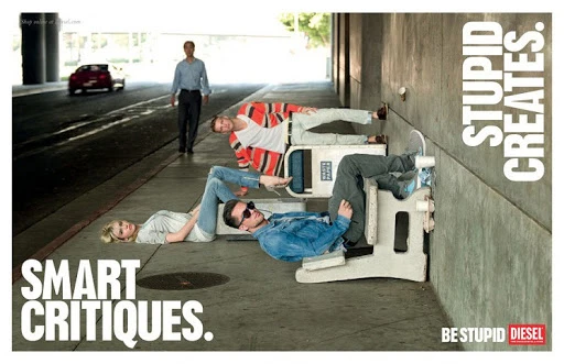 Diesel ad features three people lying horizontally in a line on the sidewalk, using white barriers as support. The background shows city street.