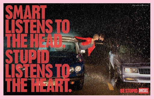 Fashion ad featuring a couple kissing on the roof of a car in the rain at night with bold text overlay and a Diesel logo.