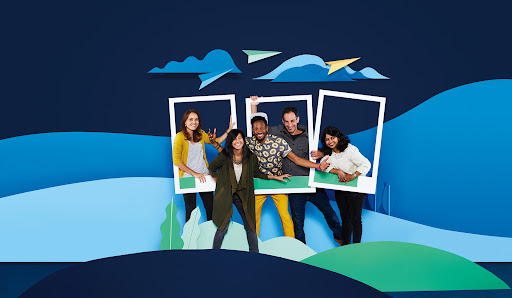 Group of diverse people posing inside cardboard frames set against a layered blue papercraft landscape by Dane Johnson