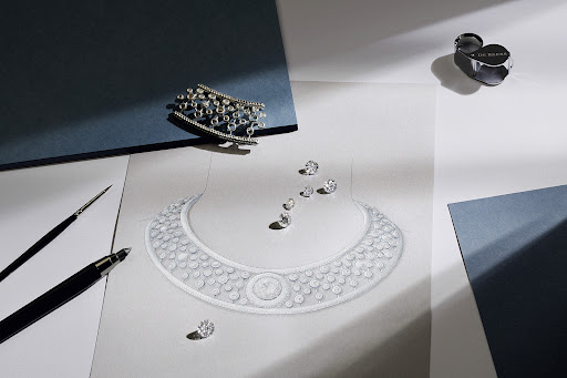 High-angle shot of an illustration of a diamond necklace, loose diamonds, jewelry, and drawing tools on a white and blue background.