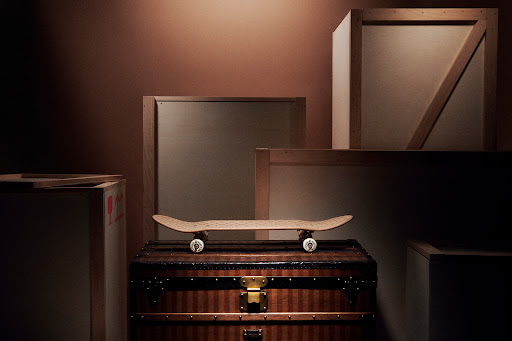 Skateboard on a vintage trunk with wooden boxes in the background, creating a stylish and nostalgic composition with warm tones.