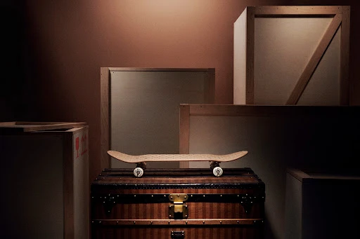 Skateboard on a vintage trunk with wooden boxes in the background, creating a stylish and nostalgic composition with warm tones.