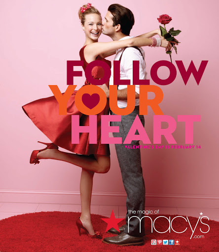 Romantic Valentine's Day-themed advertisement featuring a young couple. A smiling woman in a red dress is embraced by a man holding a rose.