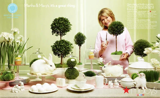 Martha Stewart next to table setting with bunnies, eggs, and topiary trees in a light green Easter-themed magazine advertisement.