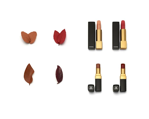 Four Chanel lipsticks arranged in a grid with corresponding autumn leaves on a white background