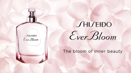 Shiseido Ever Bloom perfume bottle set against a soft background of overlapping pale pink petals