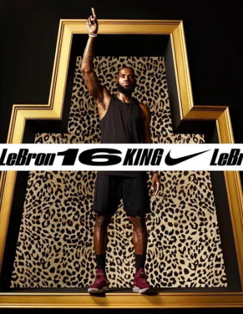 LeBron James in frame with leopard pattern and black background. He's wearing a tank top and athletic shorts, pointing upwards.