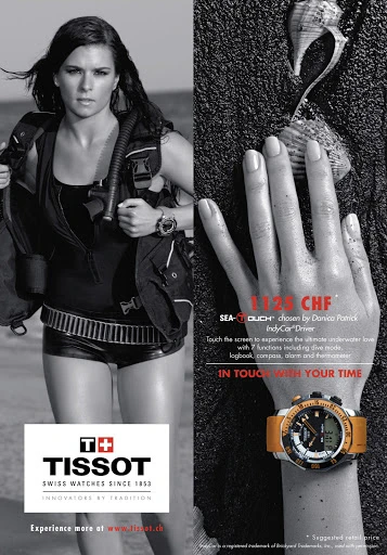 Black and white ad featuring a woman diver in gear with a wristwatch, contrasted with an eye-level view of a watch on a sandy surface.