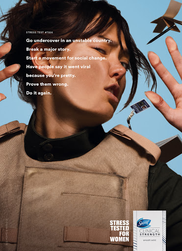 Woman in tactical vest with serious facial expression and text: 'Go undercover in an unstable country. Break a major story.'