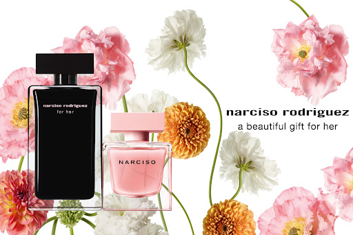 Narciso Rodriguez perfume bottles showcased with pink and white flowers on a white background, displaying elegance and floral fragrance.