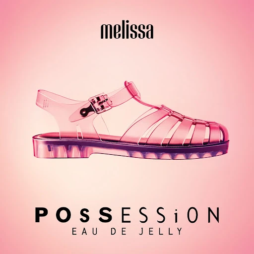 Promotional shot of a single clear jelly sandal from Melissa on a graduated pink background with Melissa brand and product name.