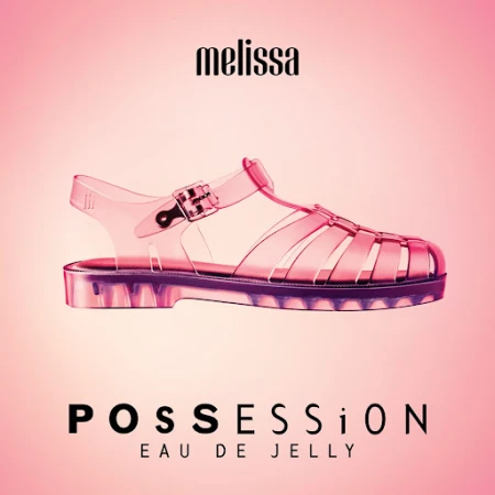 Promotional shot of a single clear jelly sandal from Melissa on a graduated pink background with Melissa brand and product name.