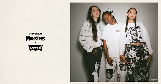 Three people model in a studio wearing Universal Monsters x Levi's branded apparel, including graphic tees and printed denim pants.