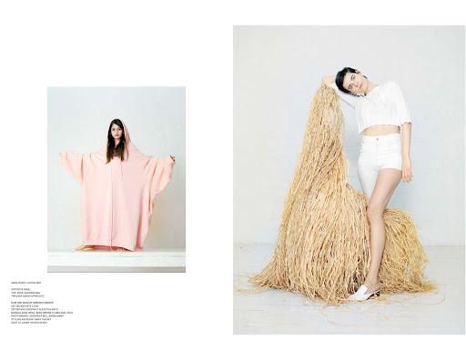 Editorial spread featuring a model in a pale pink oversized hoodie and another leaning against a tall dried grass sculpture