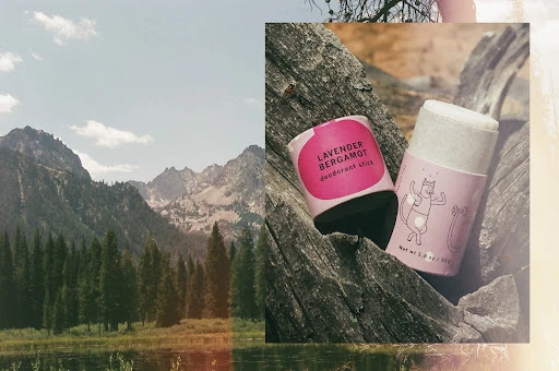 Two deodorant sticks on a wood surface with mountain background. Lavender Bergamot product for beauty and personal care.