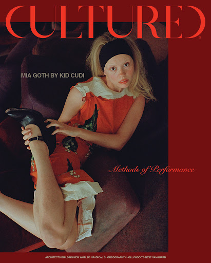Magazine cover featuring Mia Goth in a red dress and black headband, reclining on a brown couch, with 'CULTURED' in large red font.