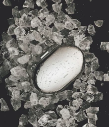 Silver metallic clutch purse resting on a bed of ice chunks and crystalline rock fragments