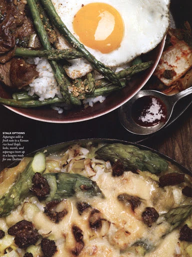 Overhead view of two food dishes: one with beef, asparagus, and a fried egg, the other with asparagus and melted cheese.
