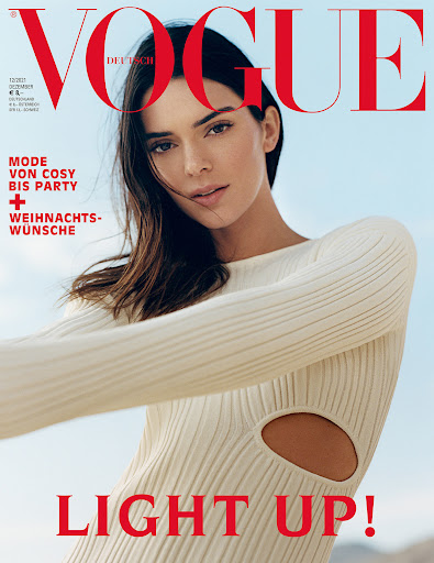 Vogue Deutsch cover featuring a brunette model in a cream sweater dress against a pale blue sky, with red magazine text.