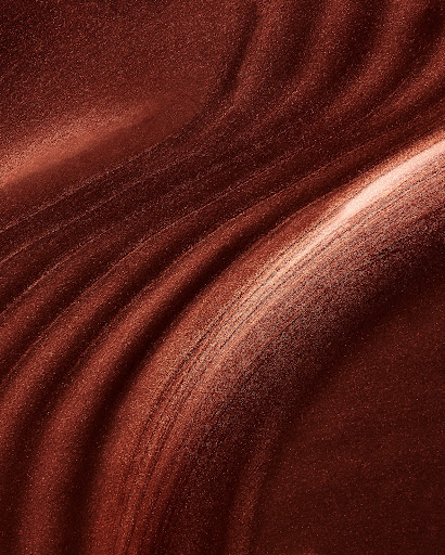 Abstract image featuring an array of swirling shapes and patterns in dark brown, copper, and light tan tones, creating a dynamic surface texture.