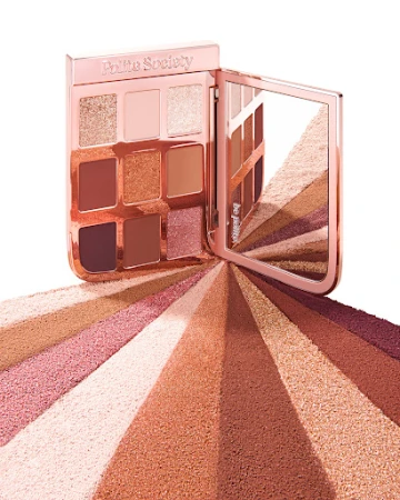 Polite Society eye shadow palette in neutral and earth tone colors with an open mirror on a white background.