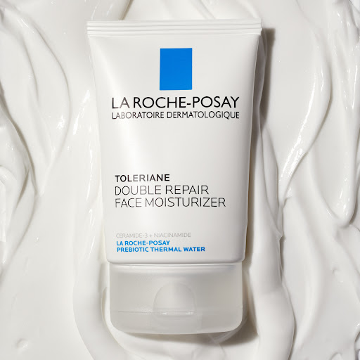 La Roche-Posay Toleriane Double Repair Face Moisturizer tube on a white textured background, showcasing the product's packaging.