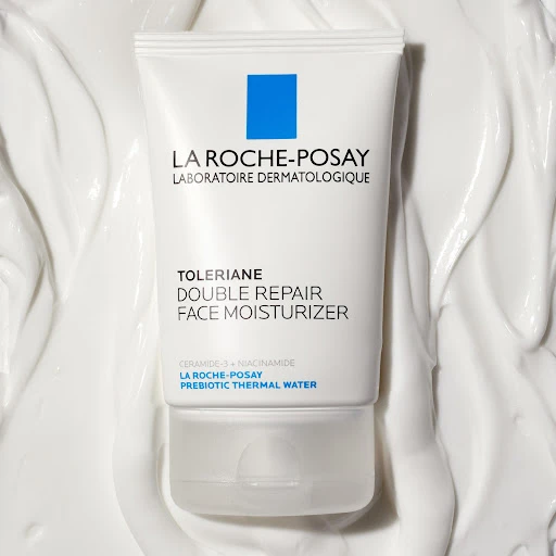 La Roche-Posay Toleriane Double Repair Face Moisturizer tube on a white textured background, showcasing the product's packaging.