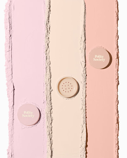 Three shades of cosmetic powder foundation are displayed in vertical columns, with a Polite Society container on each.